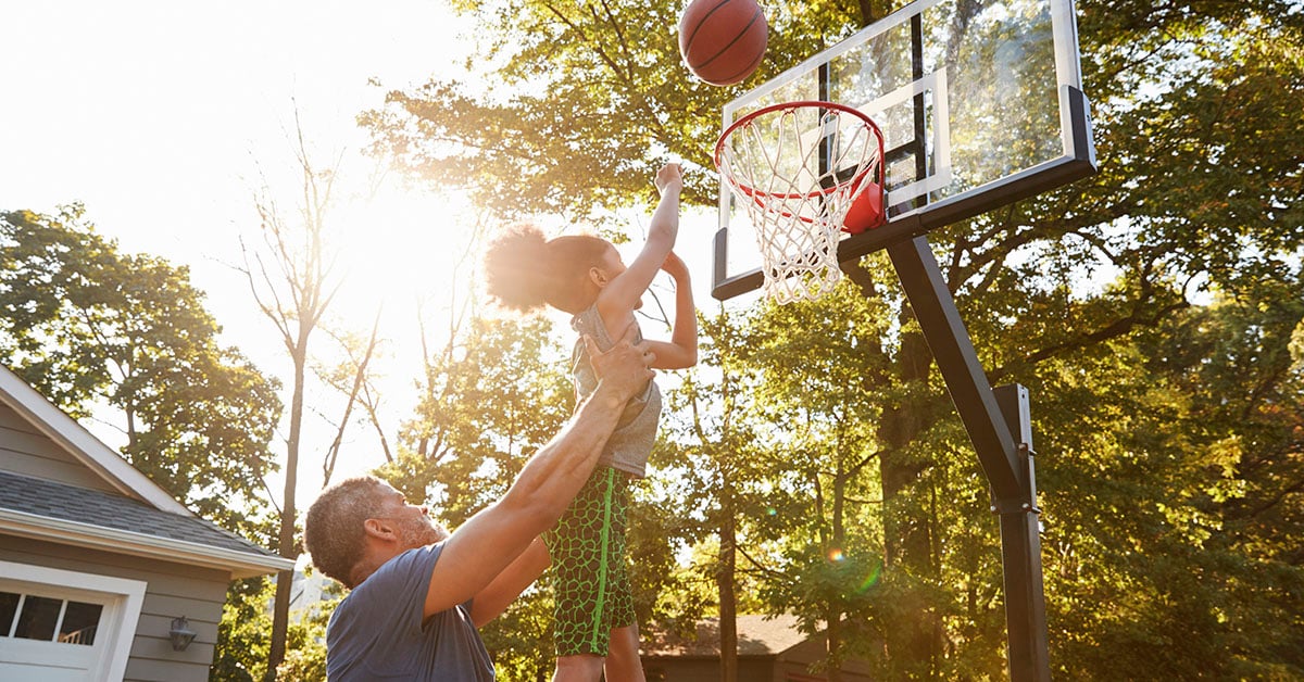 Father and child playinng basketball