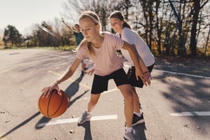 Teenage girl dribbling basketball