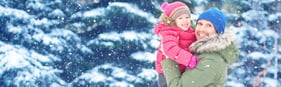 Dad and child in snow