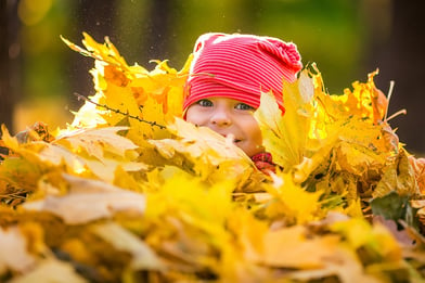 Playing in piles of leaves is a memory your kids will always cherish.