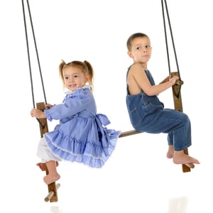 Two children on an old wood swing